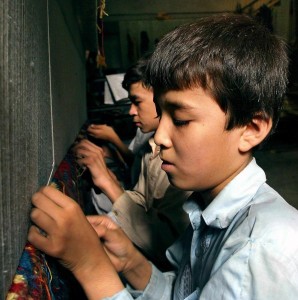 Children are busy in weaving carpets