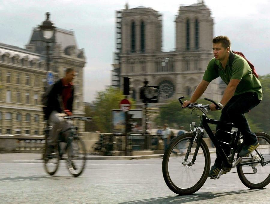 Cyclists ride in front of the Notre Dame cathedral in central Paris, Monday 22 September 2003. As 58 other cities in France, Paris experiences a day without cars. The centre of Paris had a car free day without the usual city traffic jams, but in the suburbs they experienced horrendous congestion. EPA PHOTO/EPA/OLIVIER HOSLET//