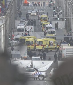 epa05225322 Emergency workers at Rue de la Loi, after an explosion at Maelbeek Metro station, Brussels, Belgium, 22 March 2016. A double explosion in the departure hall of Zaventem Airport in Brussels has left at least 13 dead and 35 wounded, sources at the General Attorney's Office of Belgium said. Hours later, blasts also rocked Shuman and Maelbeek metro stations near European Union buildings, the number of victims which remains unknown, prompting a shutdown of the metro system as authorities raised the city terror alert to the maximum level. EPA/OLIVIER HOSLET